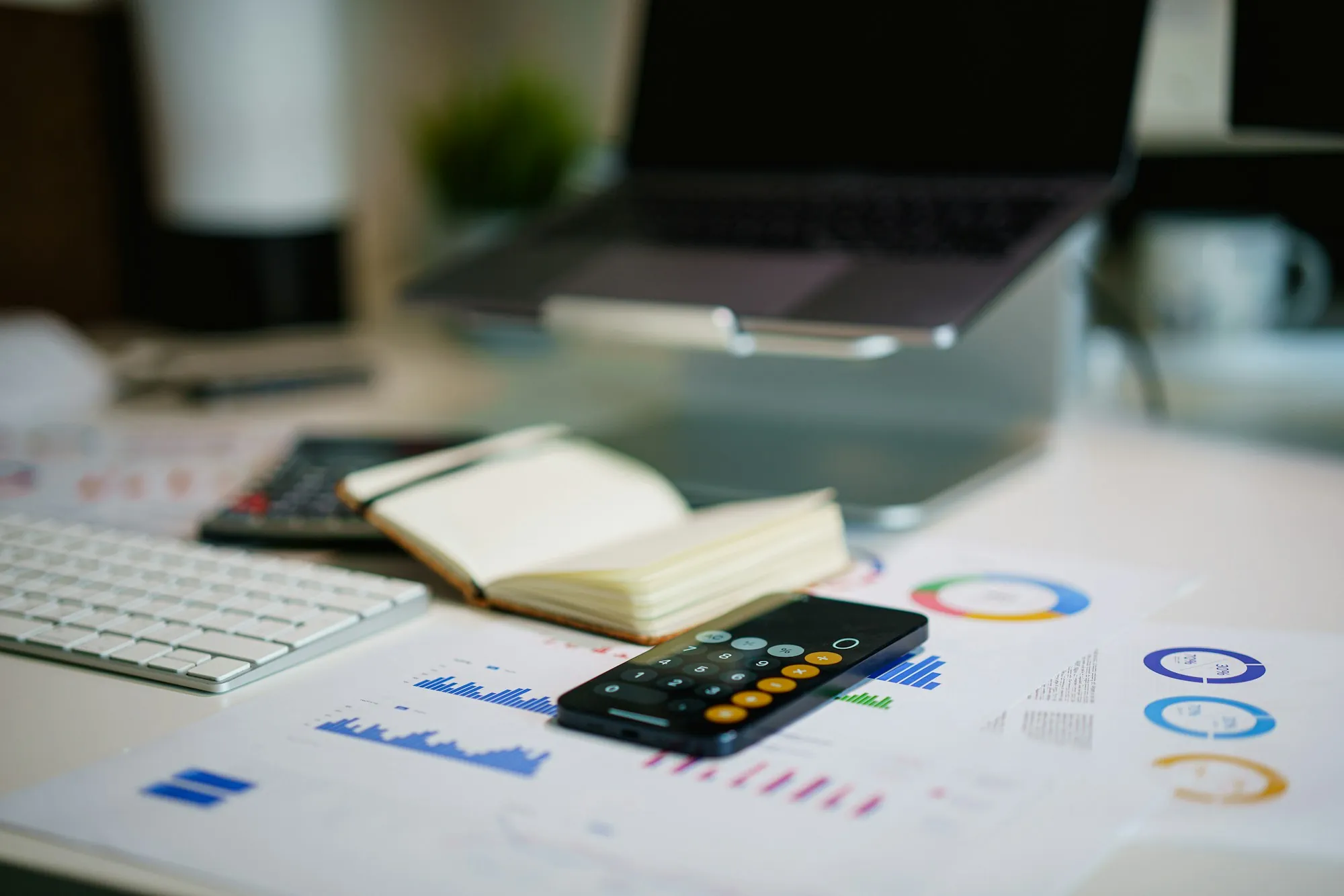 Charts, a calculator and a notebook on a desk, used to work out how cash value grows in a whole life policy for a Lincolnshire household